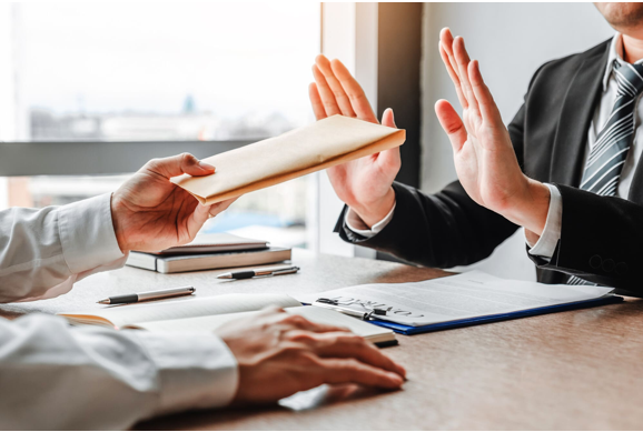 Employees participating in anti-corruption training workshop with role-plays and compliance guidelines